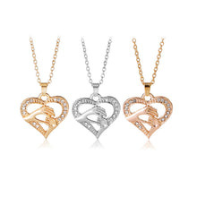 Trendy Charin Female Heart Hollow Inlaid Crystal Mom Hand with Kid Hand Nec